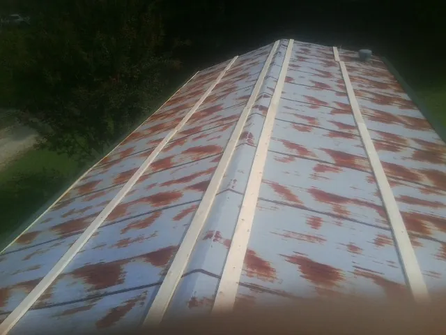 Rusted metal roof panels with new wood purlins before replacement — Storm Damage Roof Repair in Canonsburg by Roofing Brothers