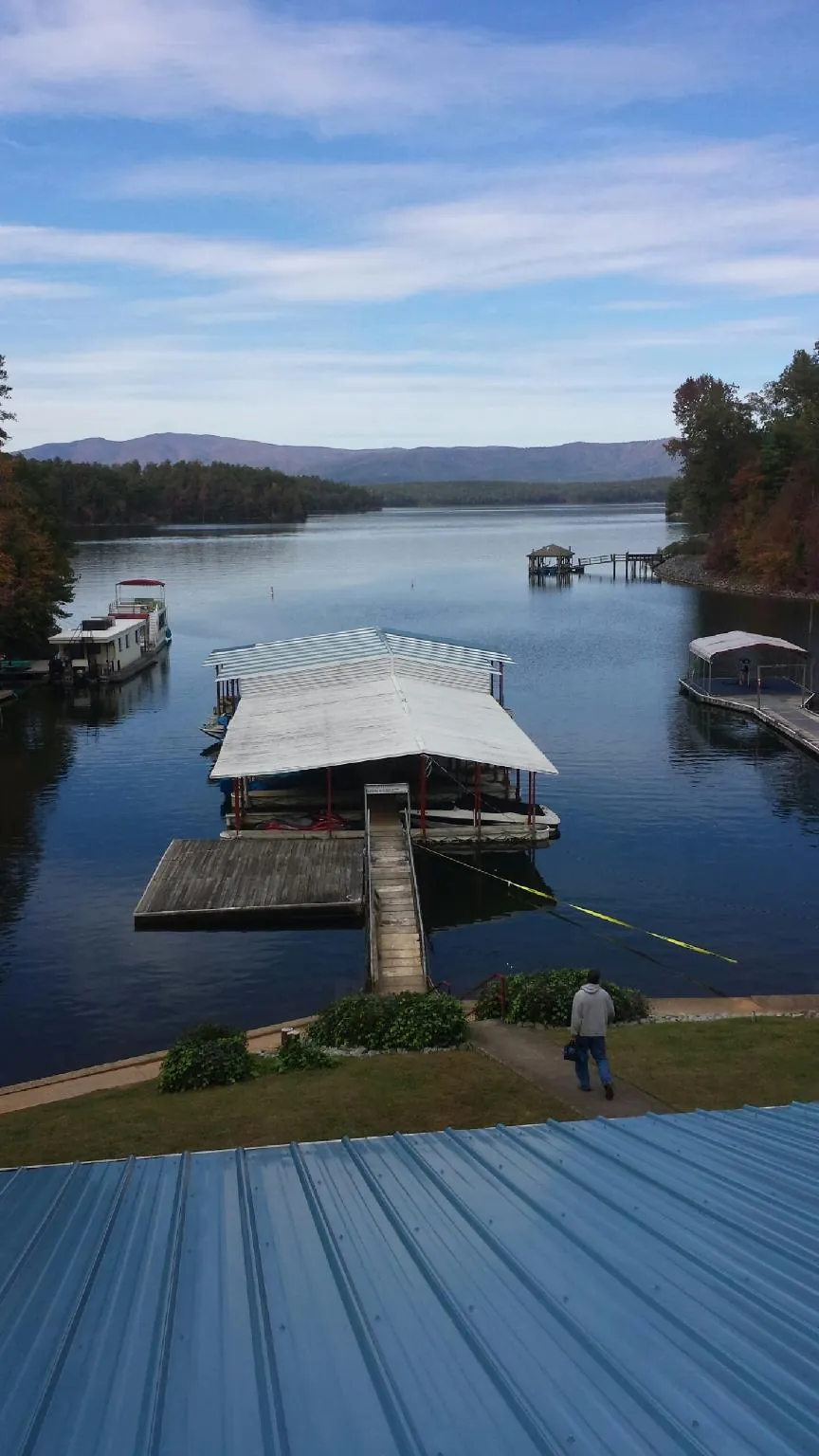 View across a lake from a newly installed blue metal roof in Canonsburg