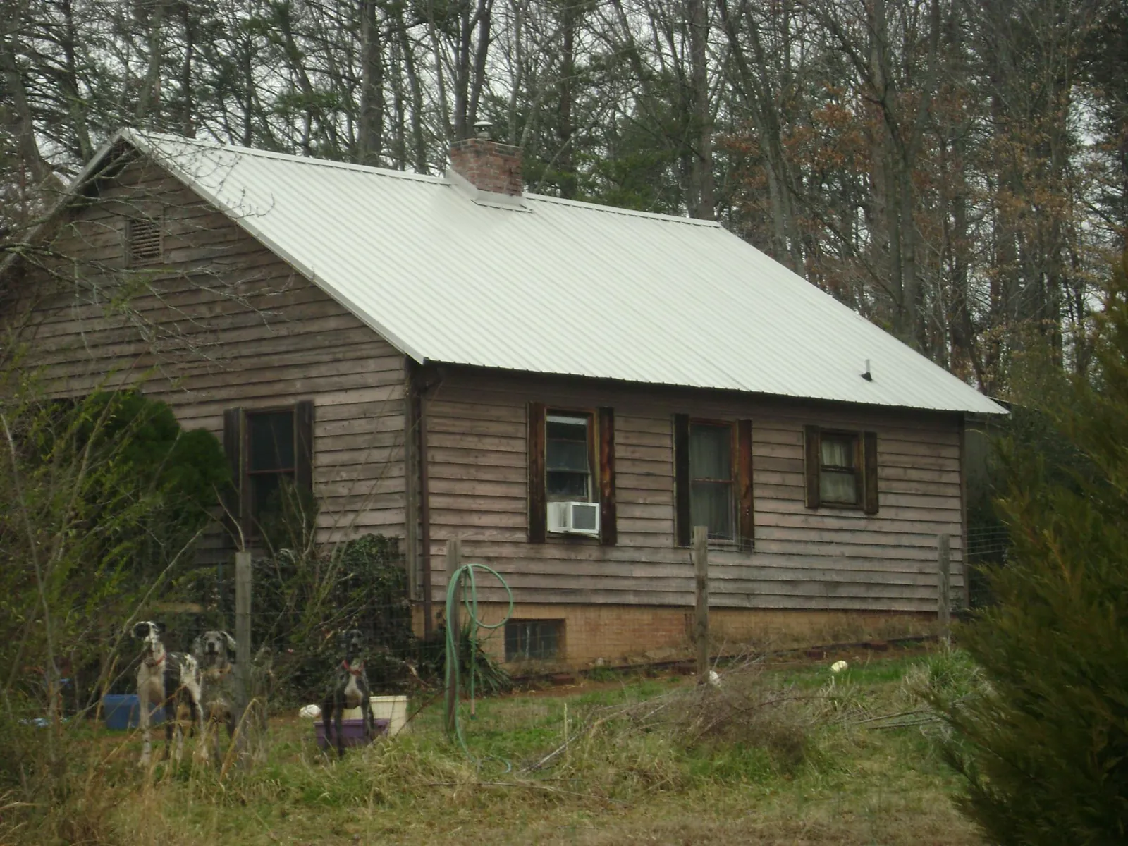 White metal roof on an old wood sided farmhouse, from a Metal Roof Installation job in Canonsburg